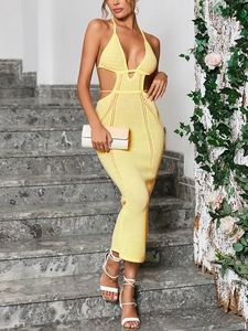 Detail of yellow knit halter maxi dress featuring deep V-neck and waist side cut-outs