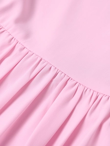 Macro detail of pink chiffon dress featuring elegant shirred texture and ruffled edge design