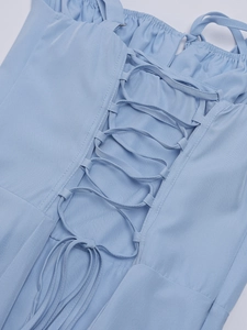 Detailed macro view of the light blue lace-up corset tie on this elegant woven dress