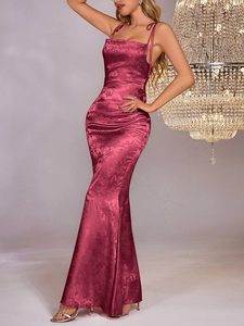 Detail of fuchsia jacquard satin texture on a slim-fit backless fishtail maxi dress