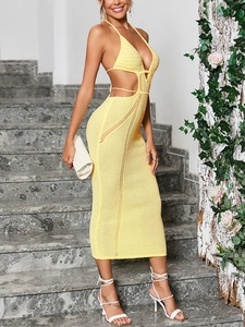 Detail of bohemian knit dress featuring a deep V-neck, waist cutouts, and crochet texture