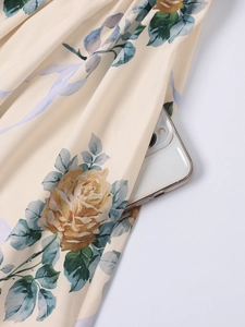 Detail view of the hidden side pocket on a floral maxi dress with rose print