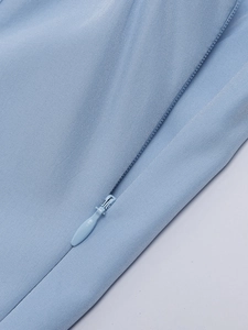 Close-up of high-quality invisible zipper on light blue fishtail maxi dress fabric