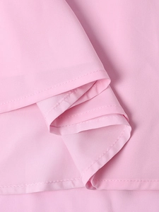 Close-up detail of double-stitched hem on light pink chiffon bodycon dress fabric