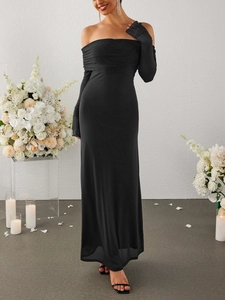 Close-up of elegant off-shoulder neckline and integrated glove sleeves on the black dress