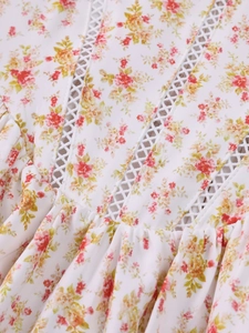 Detailed view of floral print fabric with delicate lace trim and gathering accents