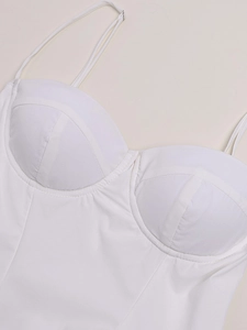 Gros plan sur un body blanc à bretelles montrant le soutien-gorge et les coutures fines