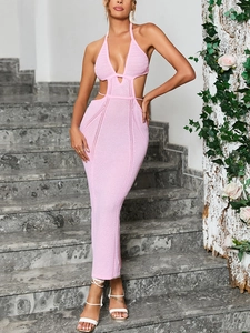 Detail of pink knitted halter dress featuring intricate crochet patterns and waist cutouts