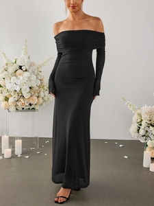 Detail of elegant black off-shoulder maxi dress with ruched long sleeves and draped texture