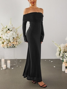 Macro detail of elegant off-shoulder black long sleeve gown with pleated neckline texture