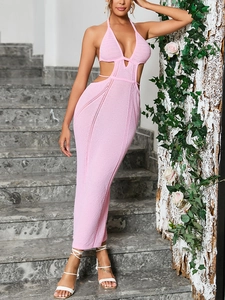 Detailed close-up of pink crochet knit dress featuring halter neck and waist cut-outs