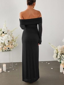 Detail of off-the-shoulder long sleeve black gown with elegant floor-length silhouette