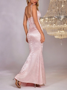 Detail of light pink floral jacquard evening dress with back tie and fishtail hem