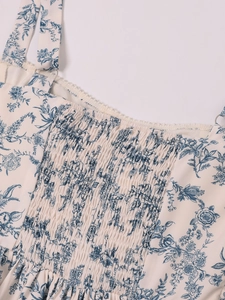 Detail view of the floral print dress featuring smocked chest design and lace trim