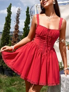 Detailed close-up of red lace trim and ruffled bodice on a mini strap dress
