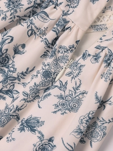 Close-up of floral slip dress featuring intricate lace trim and invisible zipper detail