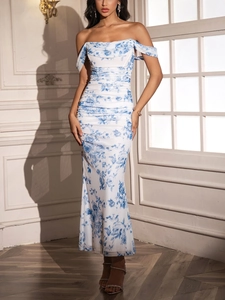 Detailed view of white off-shoulder ruched dress with blue porcelain floral patterns