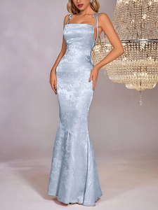 Detail of light blue satin jacquard evening dress with elegant fish tail floral pattern