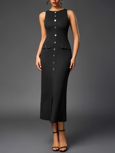 Detail of ribbed knit black dress showing front buttons, decorative pockets and side slit