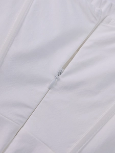 Macro shot of the invisible zipper design on this elegant white mesh dress fabric