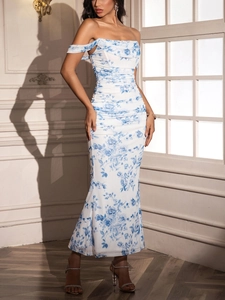 Detail of white ruched dress with blue floral print and elegant off-the-shoulder design