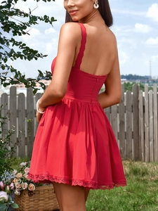 Close-up of red sleeveless dress featuring delicate lace hem and hidden back zipper
