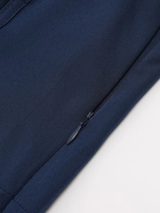 Detail of invisible zipper closure on navy blue fishbone dress with textured fabric