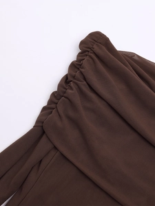 Detail of dark brown ruched mesh fabric with fine semi-sheer texture and pleated design