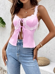 Detailansicht eines rosa Satin-Camisoles mit weißer Spitze und Schleifendetails