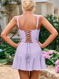 Detailed back view of a light purple lace-up mini dress with open back and crossed straps