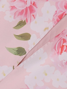 Close-up of pink floral dress fabric featuring precise stitching and high-density texture
