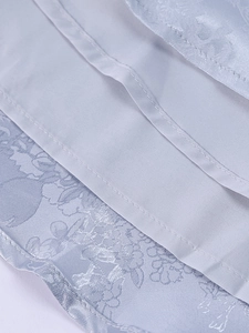 Detail shot of light blue jacquard fabric with smooth lining and premium stitching