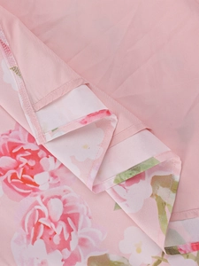 Close-up of pink rose floral print fabric with high-quality hemmed edge stitching detail