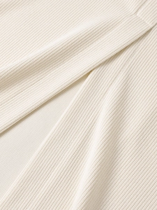 Detailed close-up of premium cream-colored ribbed knit fabric texture and soft material