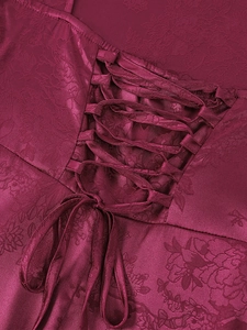 Detail of burgundy floral jacquard fabric with corset-style lace-up back design