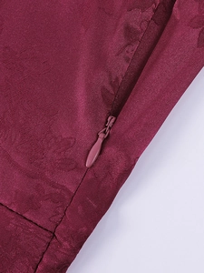Close-up of wine red jacquard dress featuring a seamless concealed zipper and satin texture