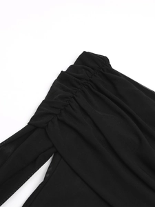 Close-up of elegant pleated black mesh shoulder detail on a long-sleeve evening dress