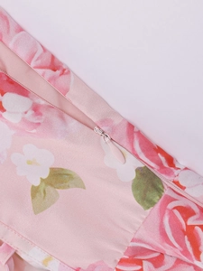 Detail shot of the hidden zipper and pink floral print on a sexy split maxi dress