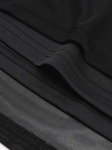 Detailed close-up of breathable mesh fabric and high-elastic knit stitching on black dress
