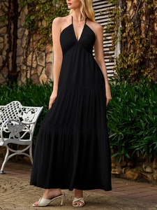 Detail view of tiered maxi dress featuring a halter-neck design and elegant deep V-neckline
