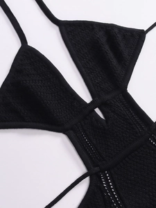 Close-up of black knitted hollow-out fabric texture with adjustable drawstring detail