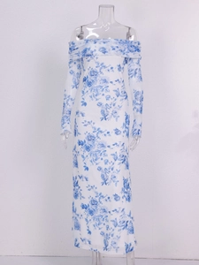 Detail of white mesh dress featuring blue rose floral print and off-shoulder neckline