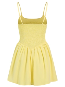 Detail view of yellow smocked dress with adjustable straps and elastic bodice texture