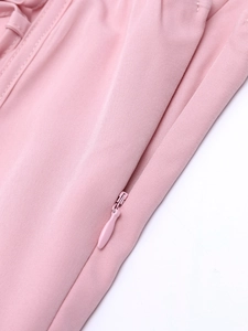 Detailed close-up of a seamless invisible zipper on a pink floral slit dress