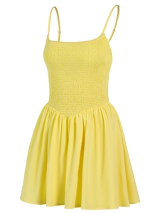 Detail of yellow smocked bodice on camisole dress with adjustable straps and pleats