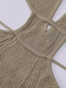 Macro detail of beige crochet knit dress showing intricate openwork patterns and texture