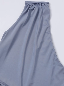 Close-up of ruched pleats and elastic gathering on a grey-purple dress knit fabric