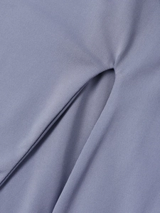Macro shot of bluish-purple knitted fabric texture with neat slit detail on the long dress