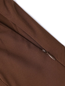 Close-up of the high-quality invisible zipper on a brown printed backless dress