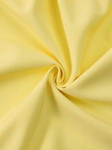 Detail of bright yellow four-way stretch fabric with pleated texture and soft drape